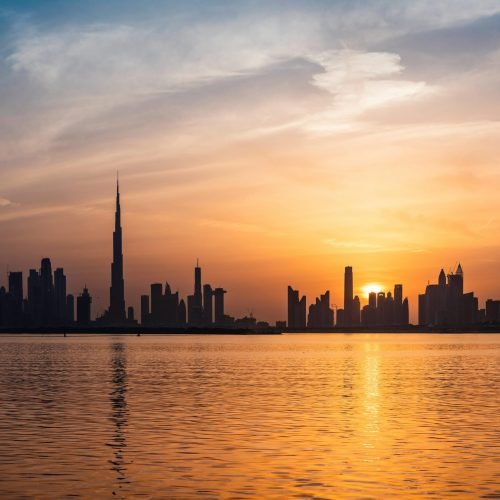pexels-photo-2115367-2115367 Enchanting view of Dubai's skyscrapers at sunset with the iconic Burj Khalifa outlined against the vivid sky.